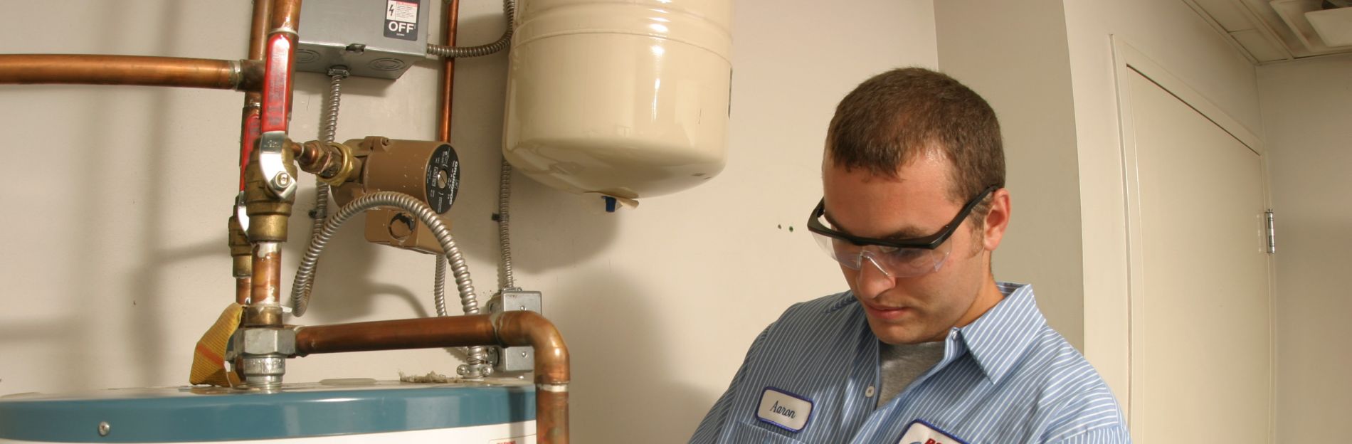 Aaron from RotoRooter working on a hot water tank repair