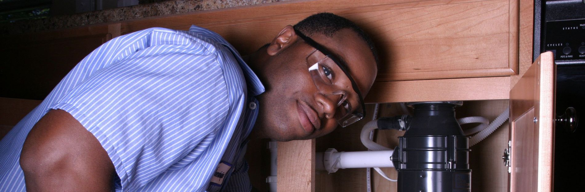 Plumber working on a kitchen sink